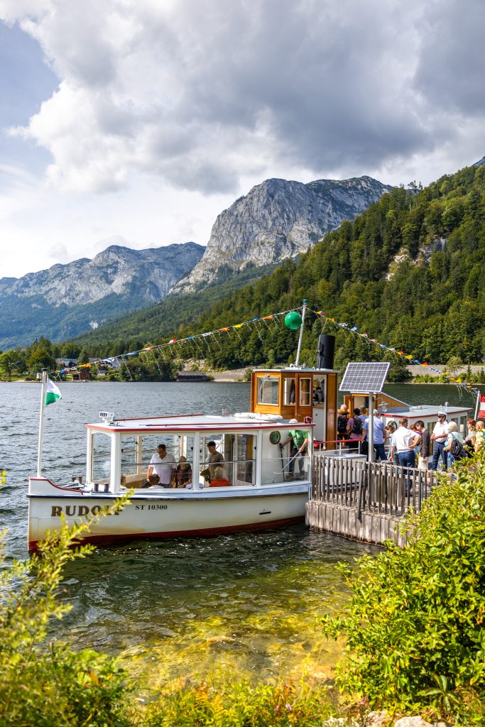 Nostalgic boat at lake Grundlsee in Ausseerland in Styria, Austria with mountain backdrop.